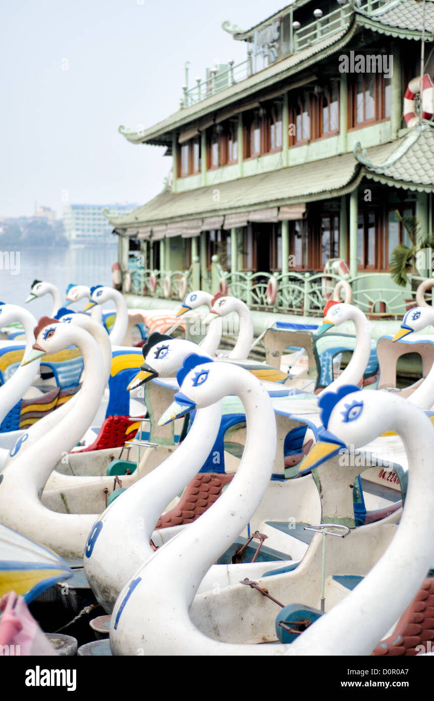 HANOI, Vietnam - Paddle boats shaped like swans are lined up at the dock of West Lake (Ho Tay) in Hanoi, Vietnam. Stock Photo