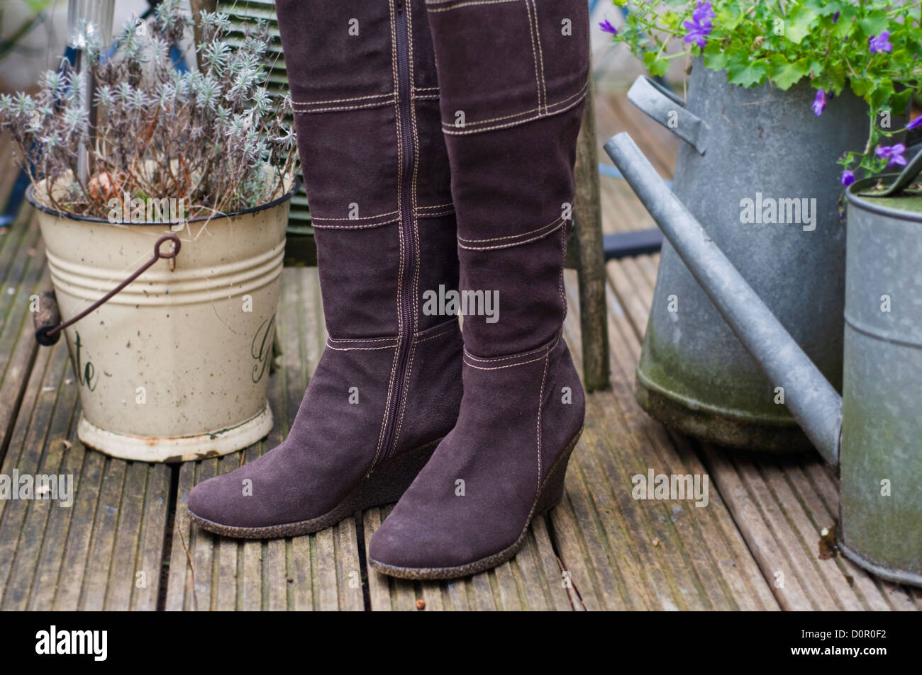 Pair of women's boots in an exterior garden setting Stock Photo