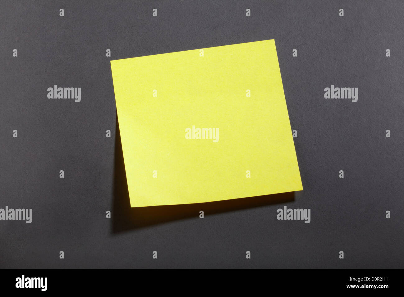 Yellow sticker note on blackboard Stock Photo