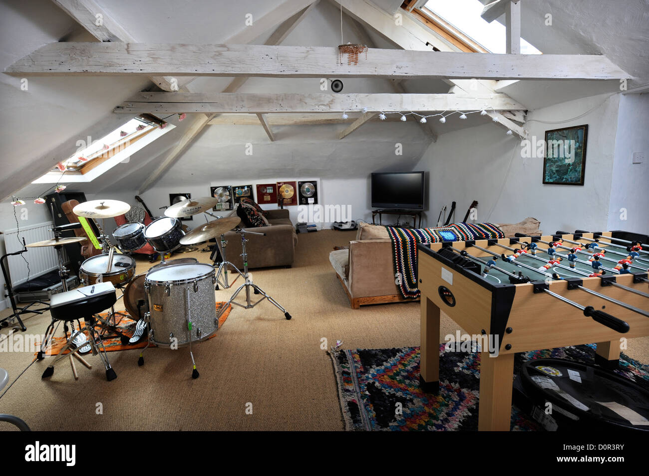 An attic games room with drum kit and table football UK Stock Photo