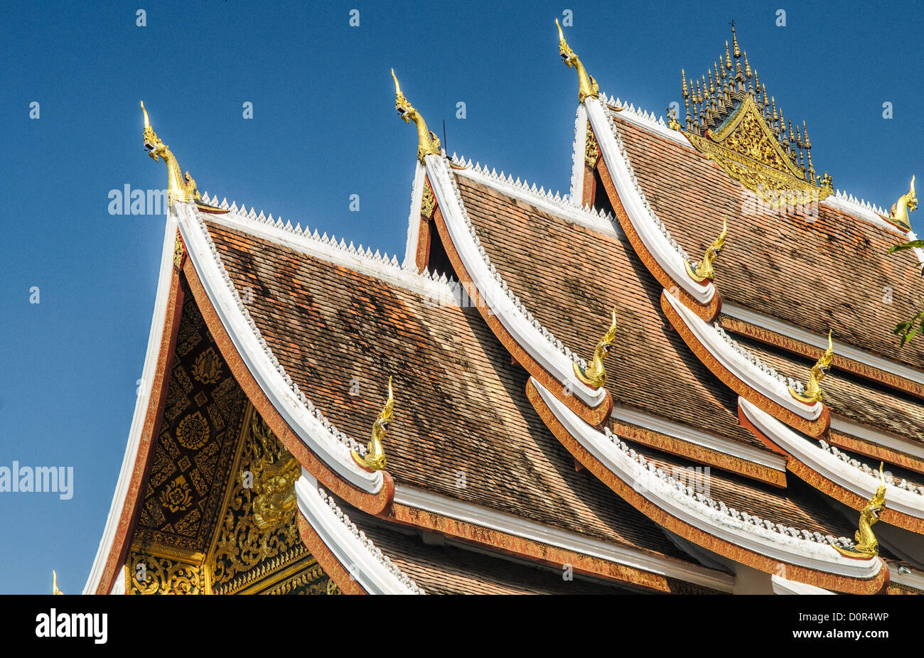 LUANG PRABANG, Laos - The multi-tiered roof at Haw Pha Bang (or Palace Chapel) at the Royal Palace Museum in Luang Prabang, Laos. The chapel sits at the northeastern corner of the grounds. Construction started in 1963. Stock Photo