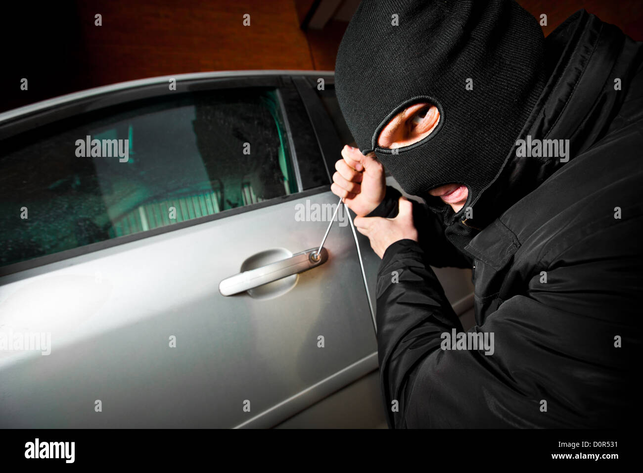 robber and the thief in a mask hijacks the car Stock Photo