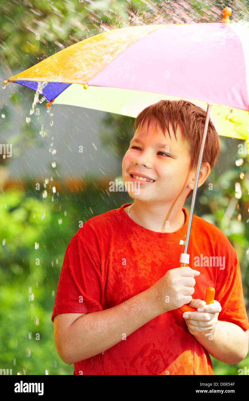 boy under an umbrella during a rain Stock Photo Alamy