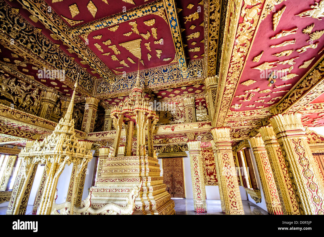 LUANG PRABANG, Laos - The ornate gold and red interior of Haw Pha Bang (or Palace Chapel) at the Royal Palace Museum in Luang Prabang, Laos. The chapel sits at the northeastern corner of the grounds. Construction started in 1963. Stock Photo