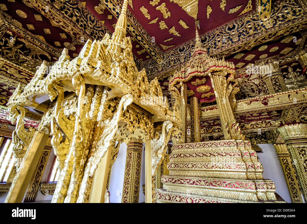 LUANG PRABANG, Laos - The ornate interior of Haw Pha Bang (or Palace Chapel) at the Royal Palace Museum in Luang Prabang, Laos. The chapel sits at the northeastern corner of the grounds. Construction started in 1963. Stock Photo