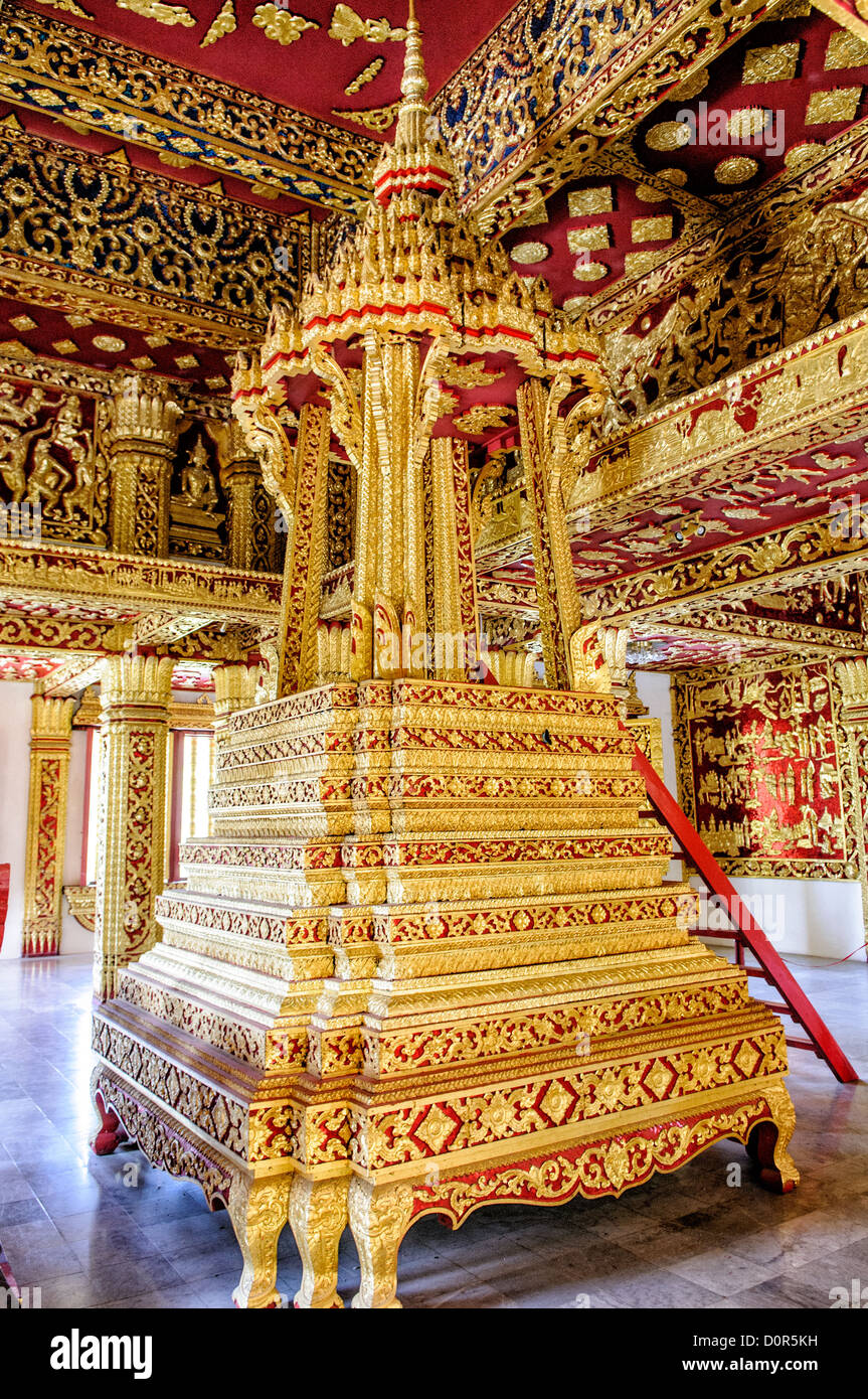 LUANG PRABANG, Laos - An ornate gold pedestal at Haw Pha Bang (or Palace Chapel) at the Royal Palace Museum in Luang Prabang, Laos. The chapel sits at the northeastern corner of the grounds. Construction started in 1963. Stock Photo