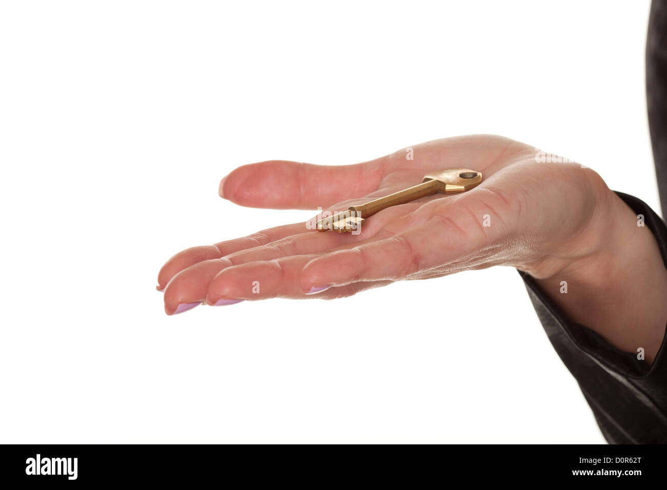 Female hand displaying a brass key Stock Photo Alamy