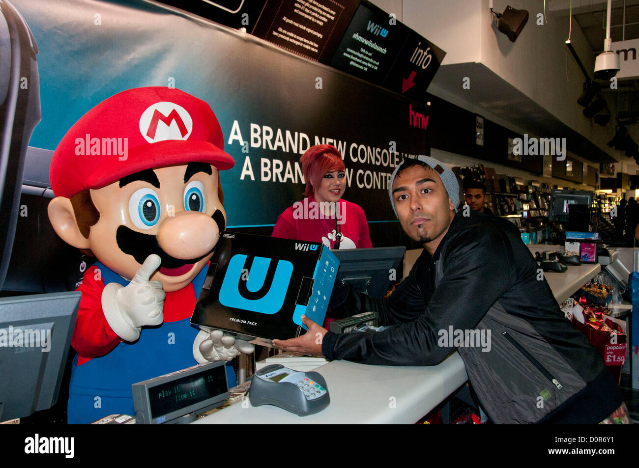 London, UK. 30/11/12. Izzy Rahmam is the first gamer to get his hands on  the brand new games console, the Nintendo Wii U. Izzy has been camping  outside HMV's flafship store on