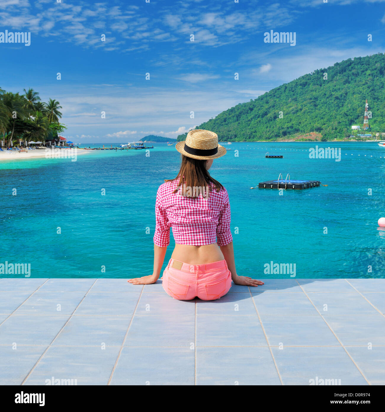 Woman at beach jetty Stock Photo - Alamy