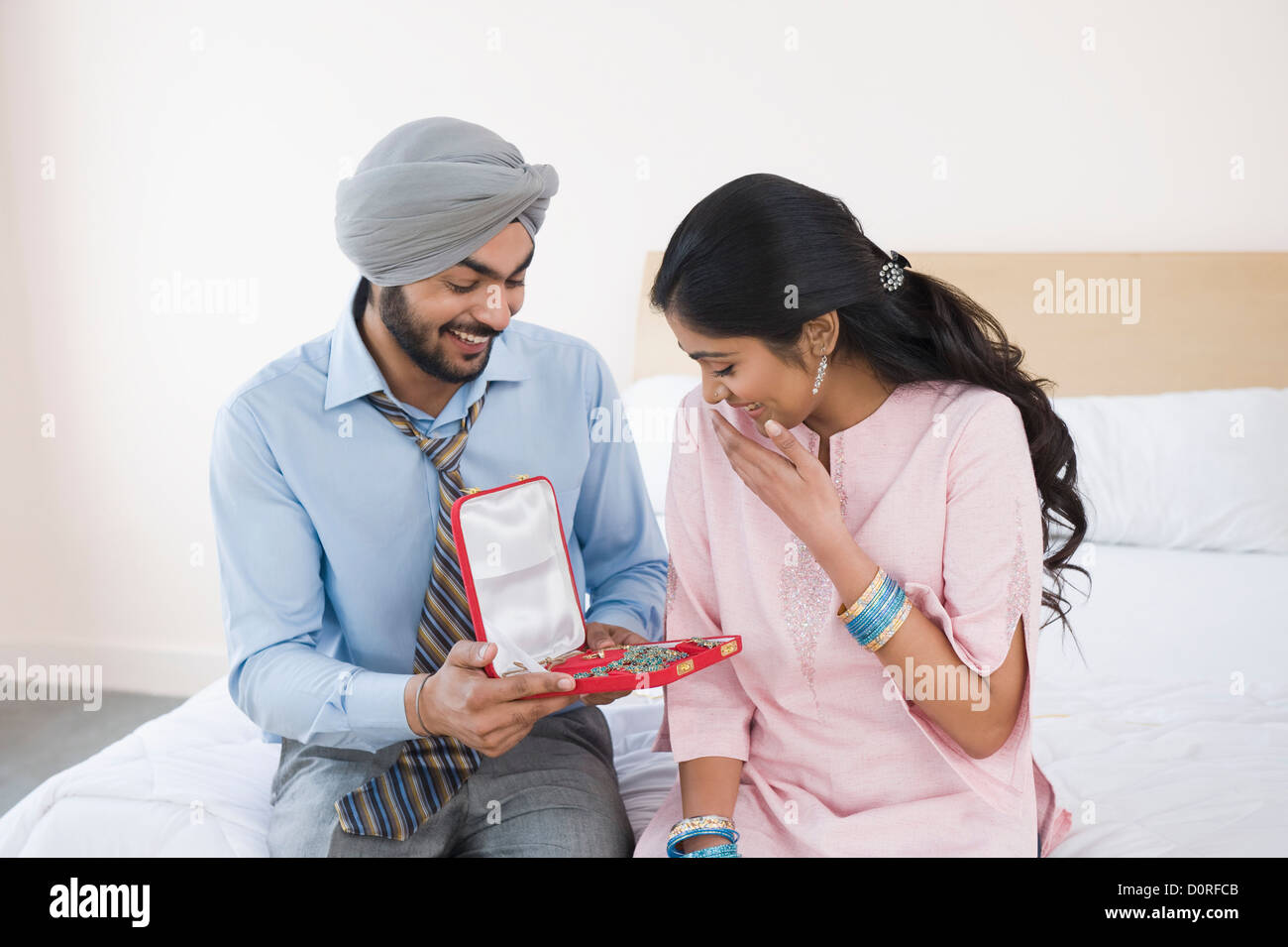 Man giving a necklace to a woman Stock Photo Alamy