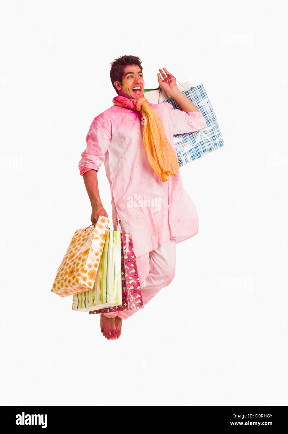 Man carrying shopping bags on Holi Stock Photo Alamy