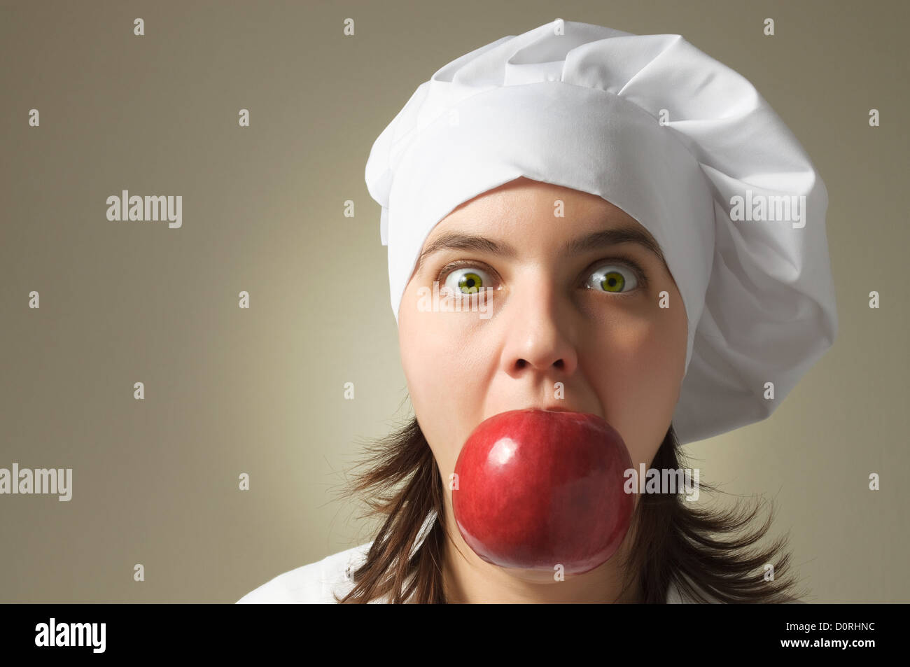 Chef with an apple in her mouth Stock Photo Alamy