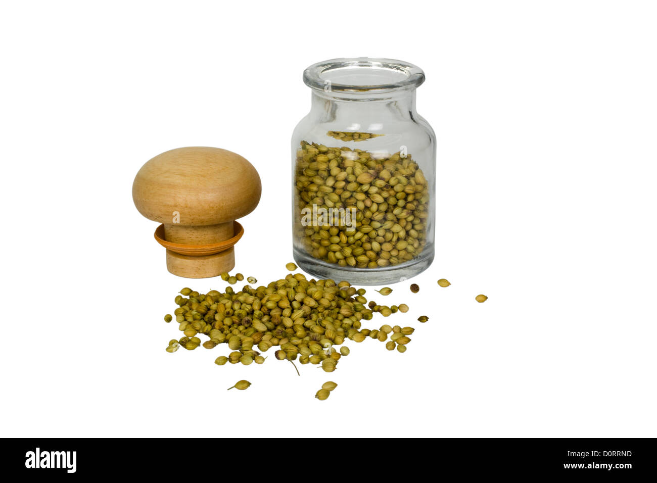 Coriander seeds spilling out from a container Stock Photo Alamy