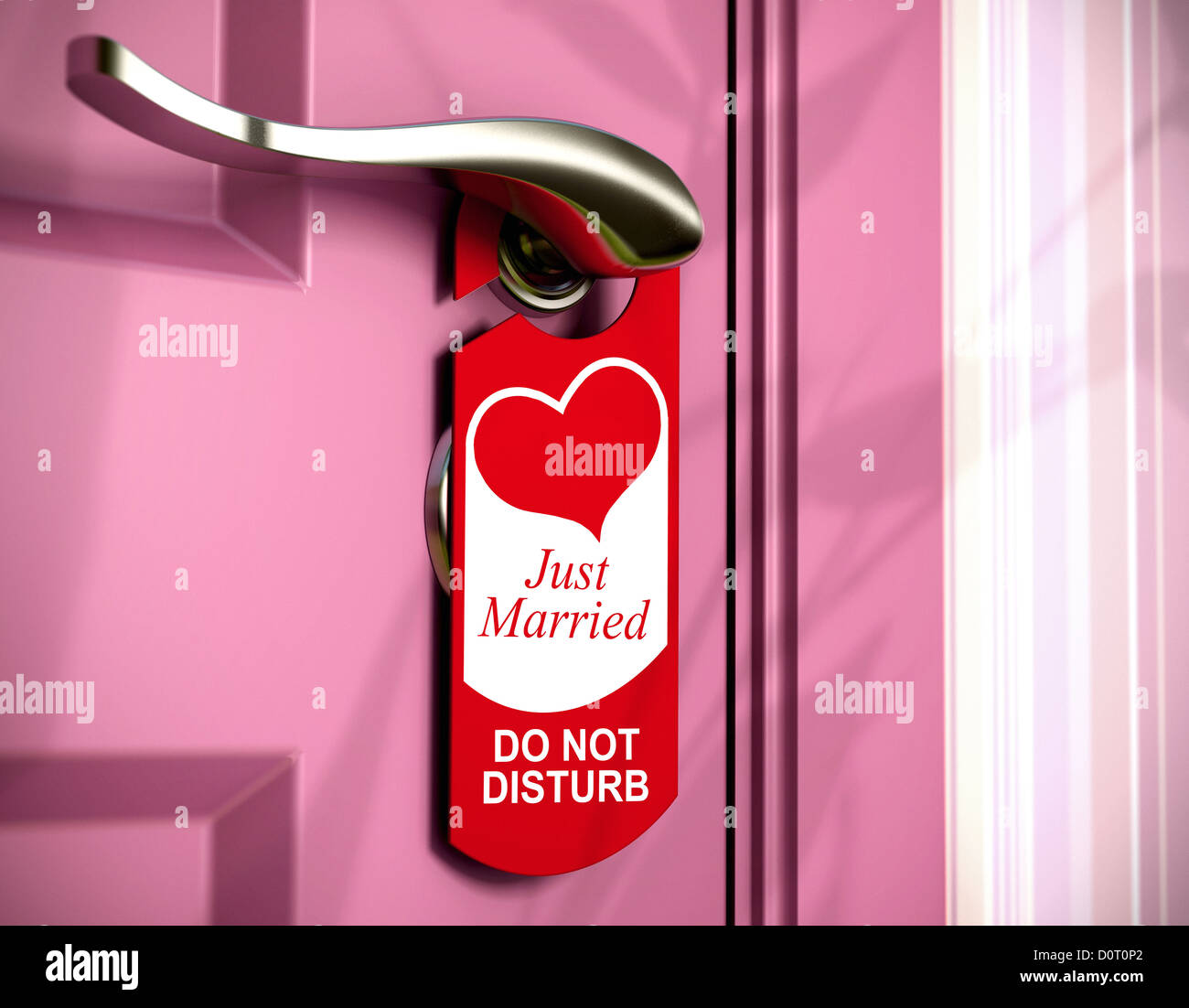 just married written onto a red door hanger, hanged on a metal handle of a pink bedroom door, concept of honeymoon. Stock Photo