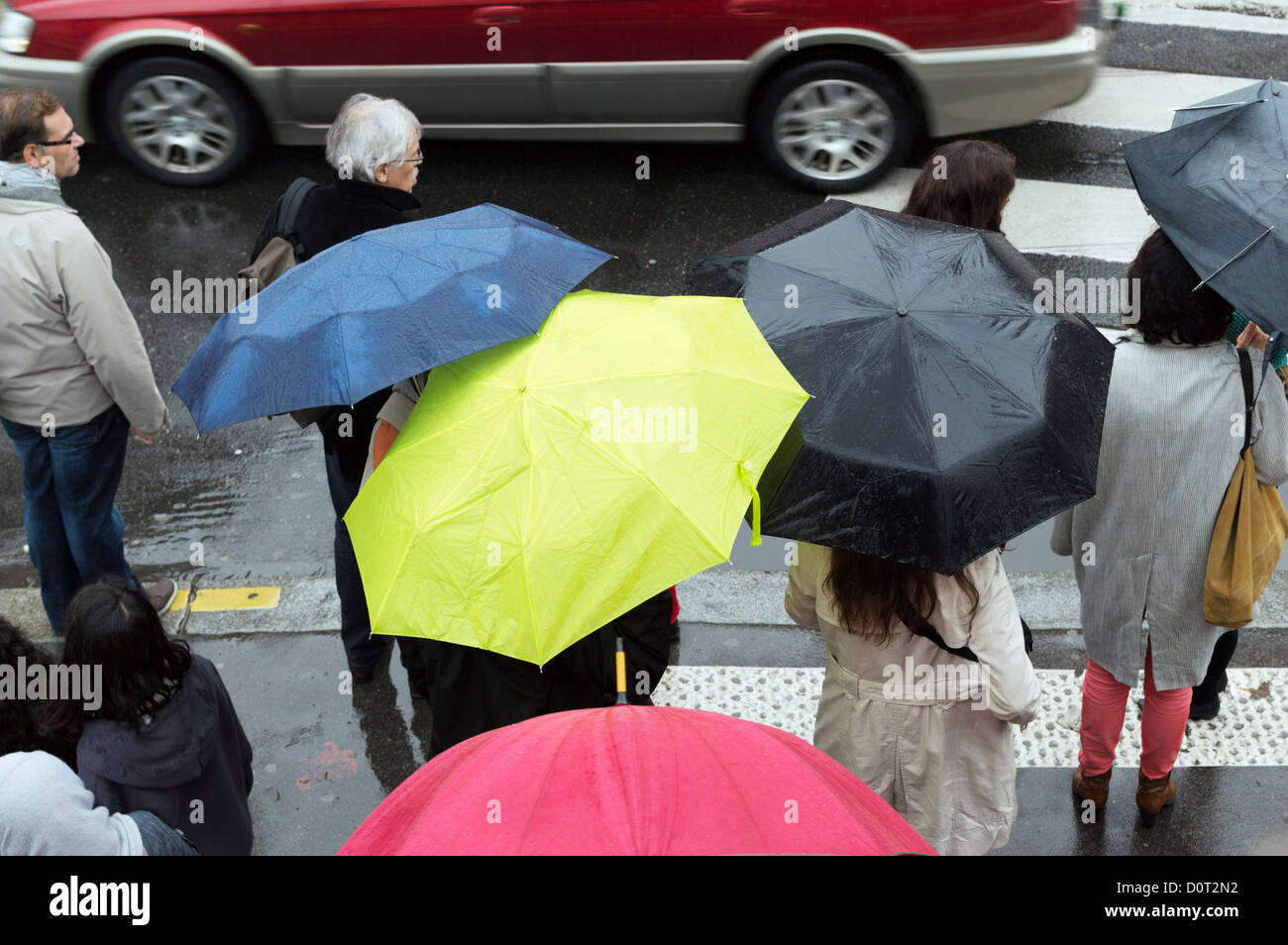 Paris, France: Pedestrians with umbrellas on a city street in the rain. Stock Photo