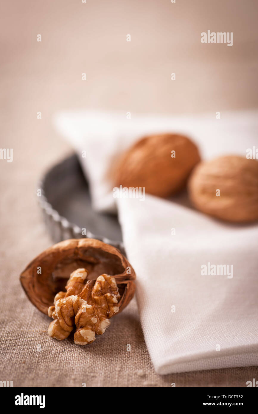 Decorative, sparse christmas arrangement with greeting card copyspace for 'Merry Christmas'-text. Close-up of an opened walnut w Stock Photo