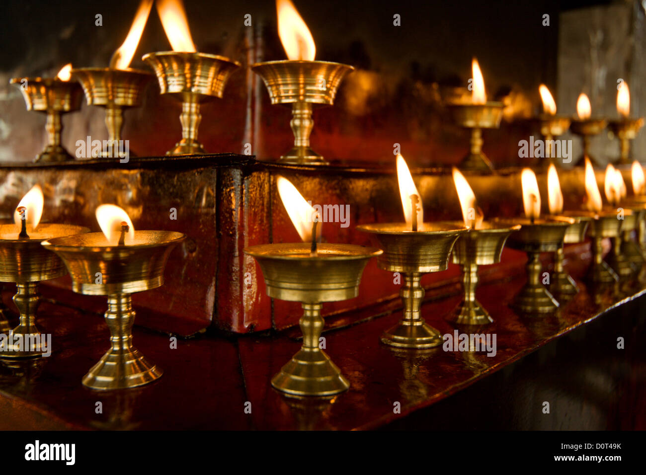 Some rows of candles in Tibetan temple Stock Photo