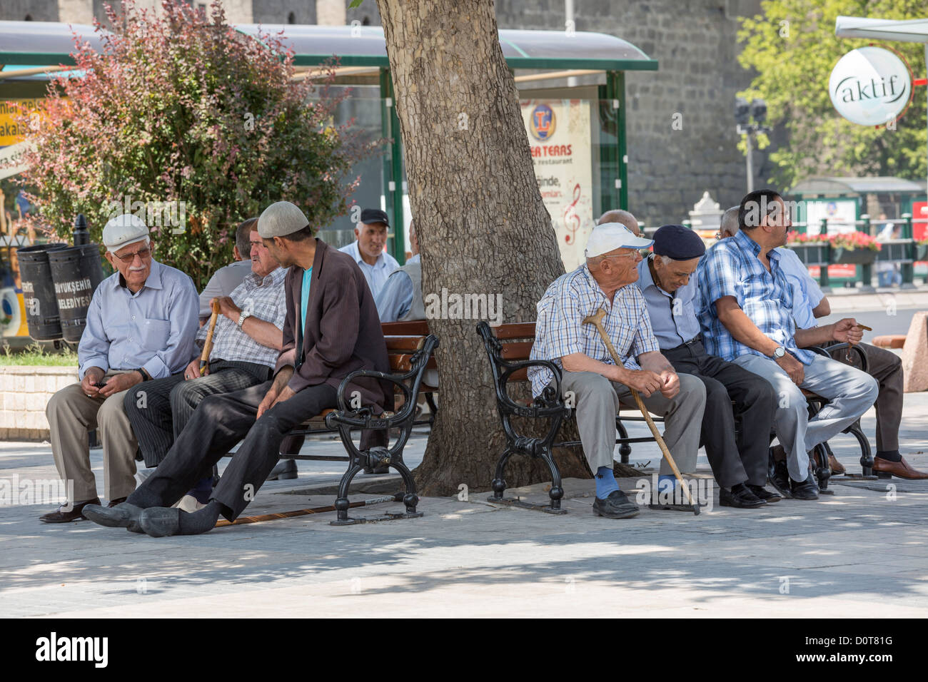 groups of old men resting on benches in public square, Kayseri, Anatolia, Turkey Stock Photo