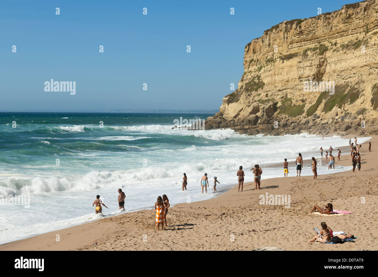 Bathers in the small beach of Foz, Sesimbra, Portugal Stock Photo