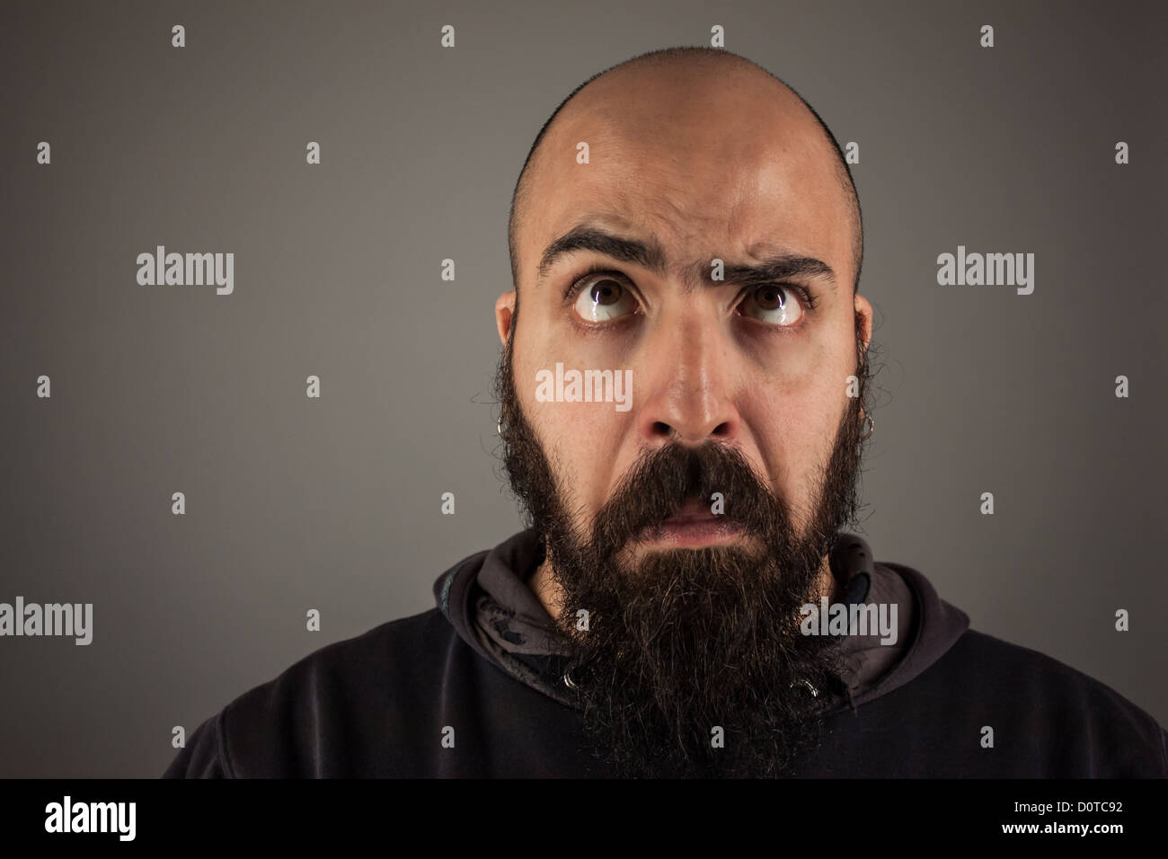 Bearded man doubtfully thinking Stock Photo