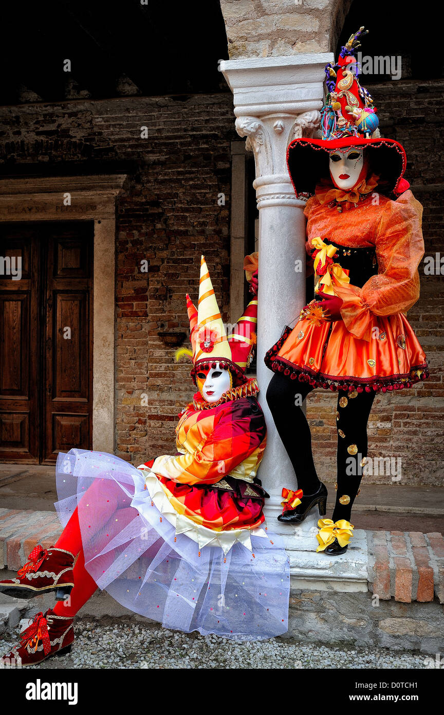 Masked participants posing in the Arsenal District during Carnival in Venice, Italy Stock Photo