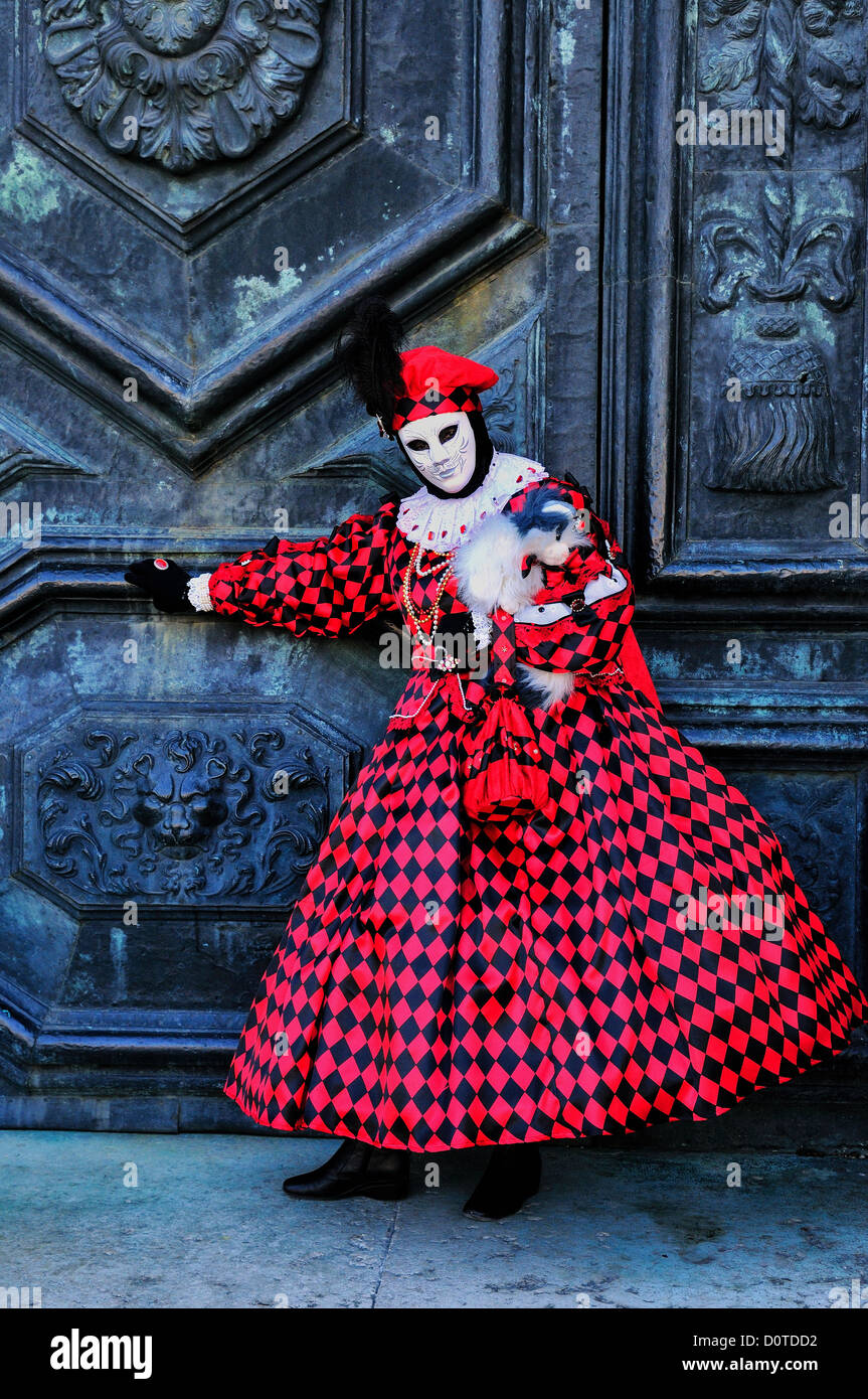 Masked woman at the door of the Basilica di Santa Maria della Salute during Carnival in Venice, Italy Stock Photo