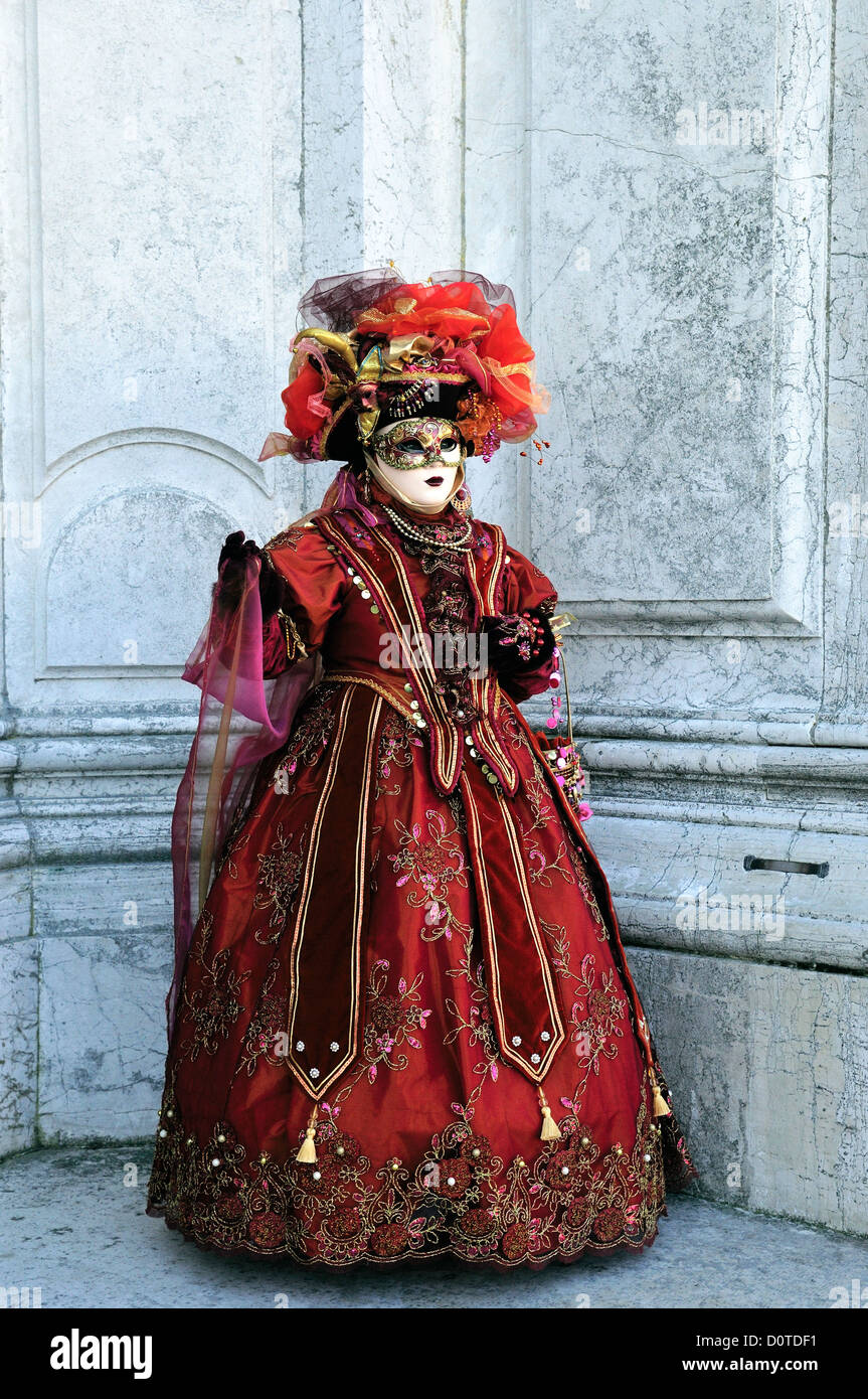 N0216-3542 Masked woman on the steps of the Basilica di Santa Maria della Salute during Carnival in Venice, Italy Stock Photo