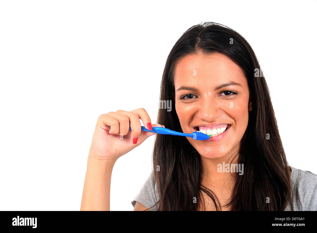 Isolated young casual woman cleaning teeth Stock Photo Alamy