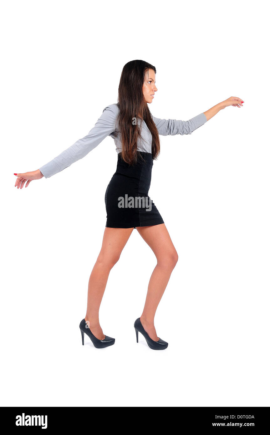 Isolated young business woman walking rope Stock Photo - Alamy