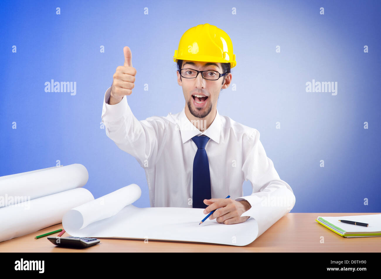 Young engineer looking at drawings Stock Photo - Alamy
