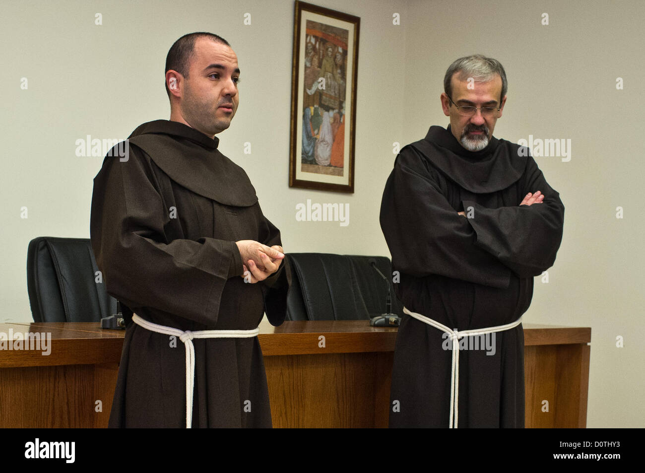 Jerusalem, Israel. 30th November 2012. The Custos of the Holy Land, Father Pierbattista Pizzaballa (R), listens as Brother Alberto (L), a university graduate and musician, explains the circumstances under which he decided to become a Franciscan monk and serve in the Holy Land. Jerusalem, Israel. 30-Nov-2012.  Of the 20,000 Franciscan monks worldwide about 300 reside in Israel as well as some 1,000 nuns. Saint Francis Francesco of Assisi first arrived in the Holy Land in 1219 and they have been custodians of the holy sites ever since. Stock Photo