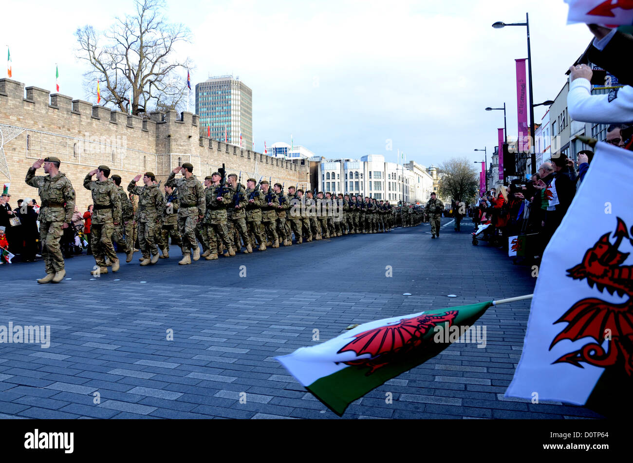 Cardiff, Wales, UK. 30th November 2012. 1st Battalion Welsh Guards have paid tribute to four soldiers who died whilst on tour with them in Afghanistan, as soldiers from the battalion march through the streets of Cardiff. More than three hundred soldiers from 1st Battalion Welsh Guards have marched through Cardiff this afternoon after a six-month tour of Afghanistan. The day started with a service of rememberance for the four members of the battalion who died during the operation. The total number of Welsh personnel killed has now risen to 32. Credit:  andrew chittock / Alamy Live News   Stock Photo
