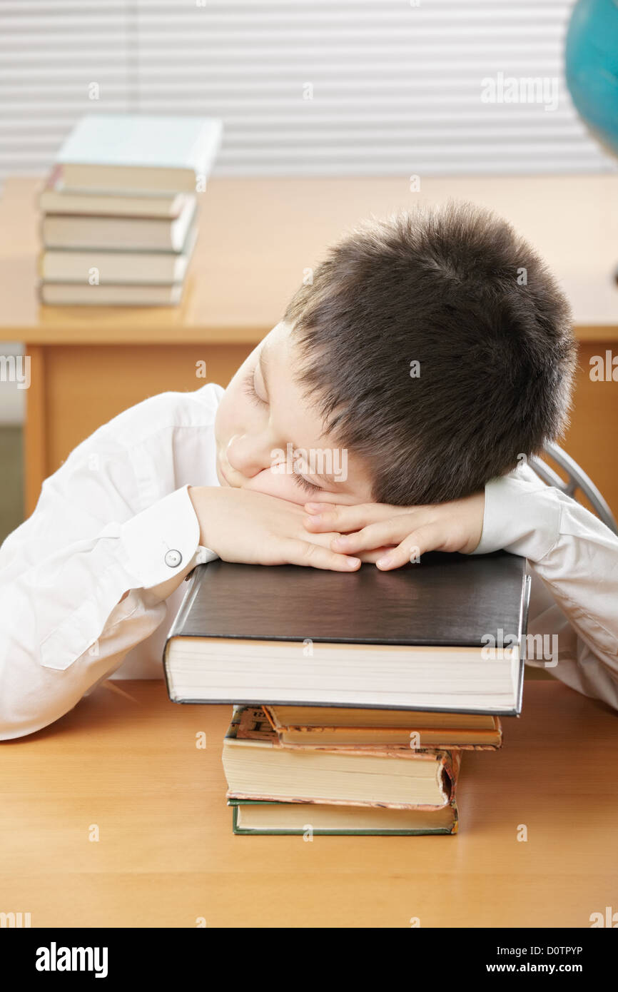 Boy sleeping on stack of books Stock Photo - Alamy