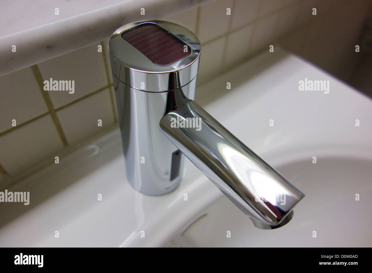 Automatic faucet with photovoltaic cell for powering infrared sensor Stock Photo