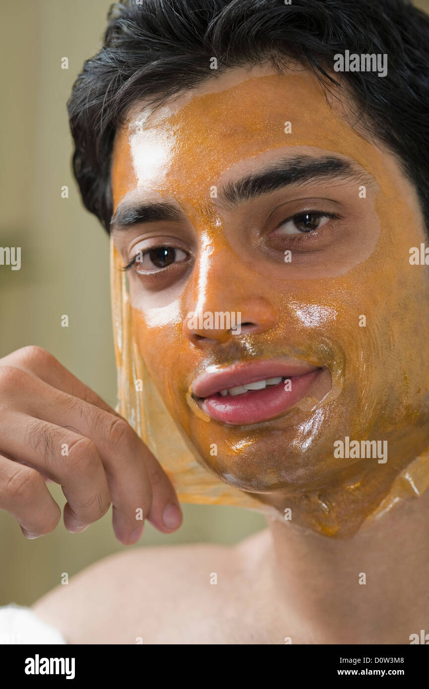 Portrait of a man peeling off facial mask from face Stock Photo Alamy