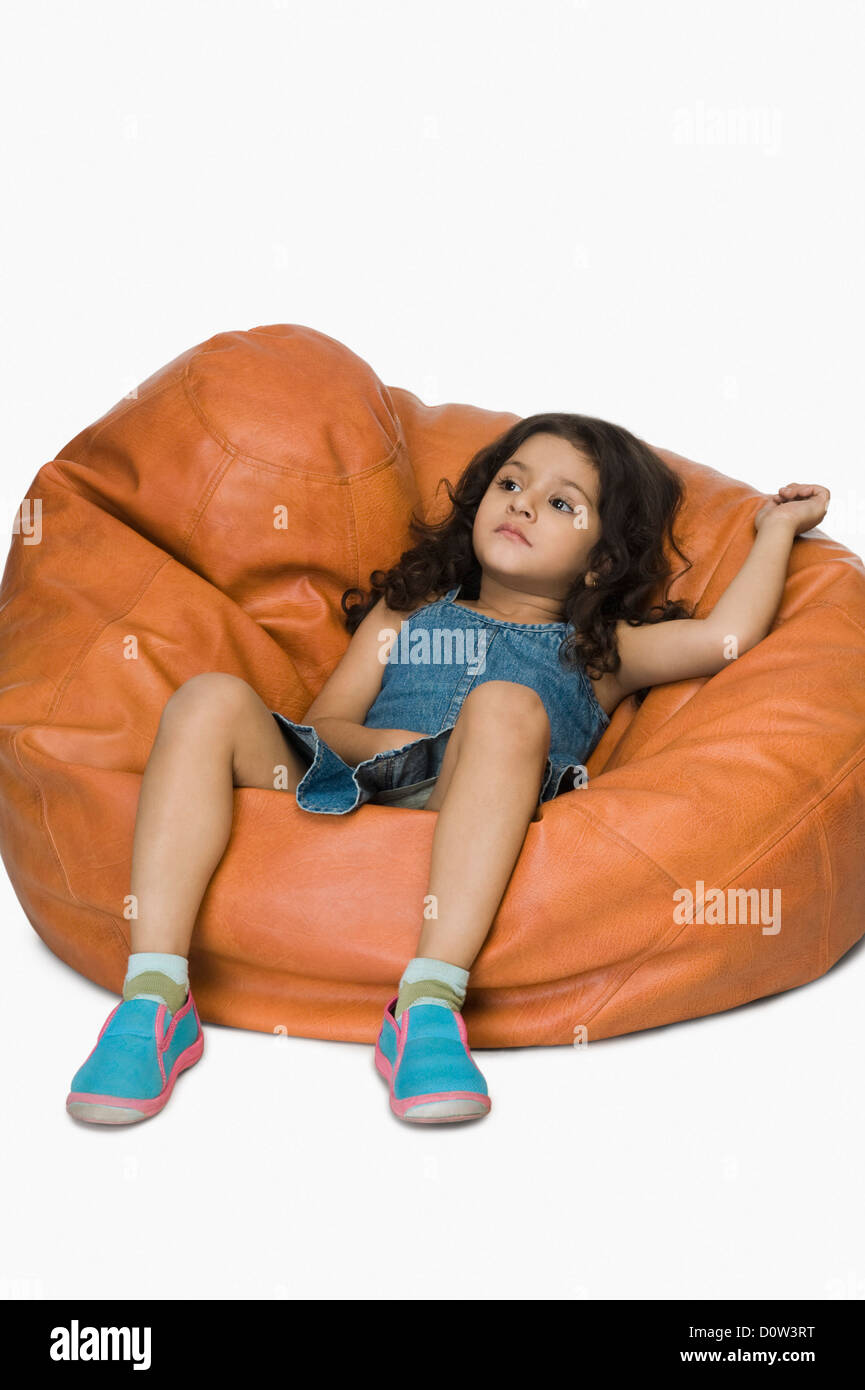 Girl relaxing on a bean bag Stock Photo - Alamy