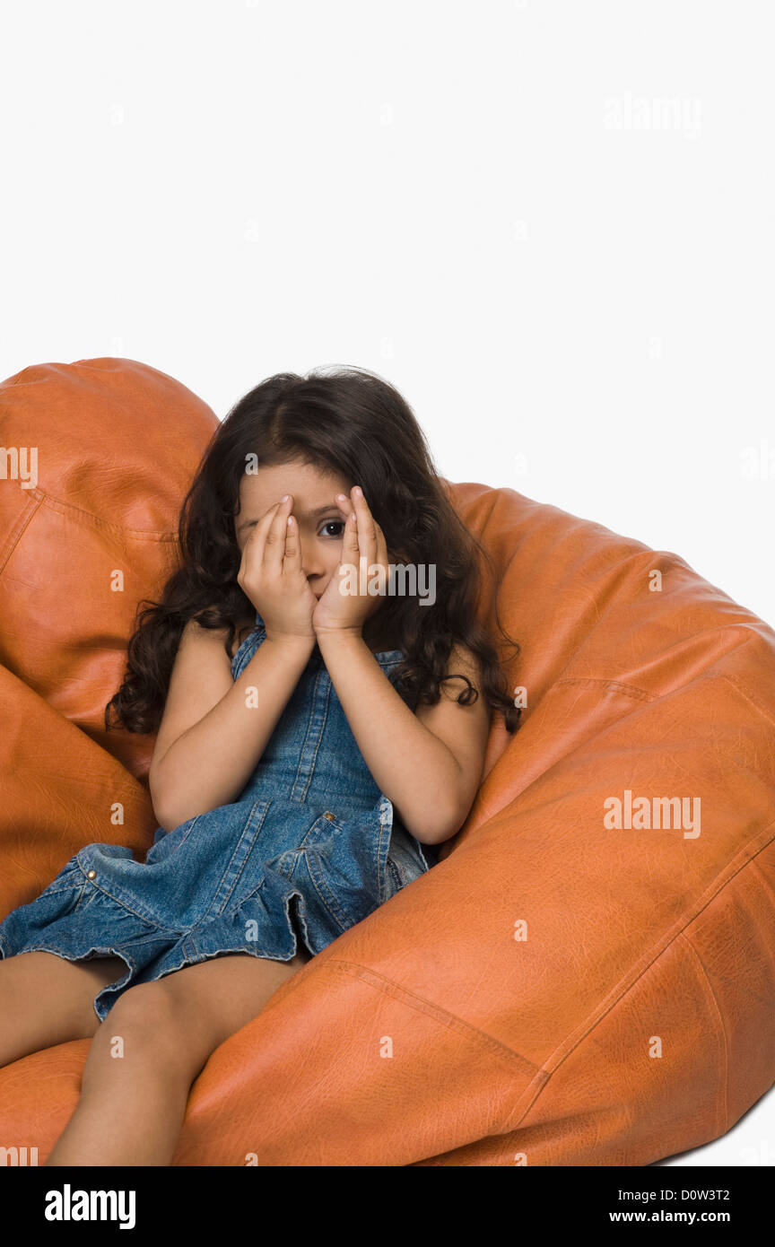 Girl playing on a bean bag Stock Photo - Alamy