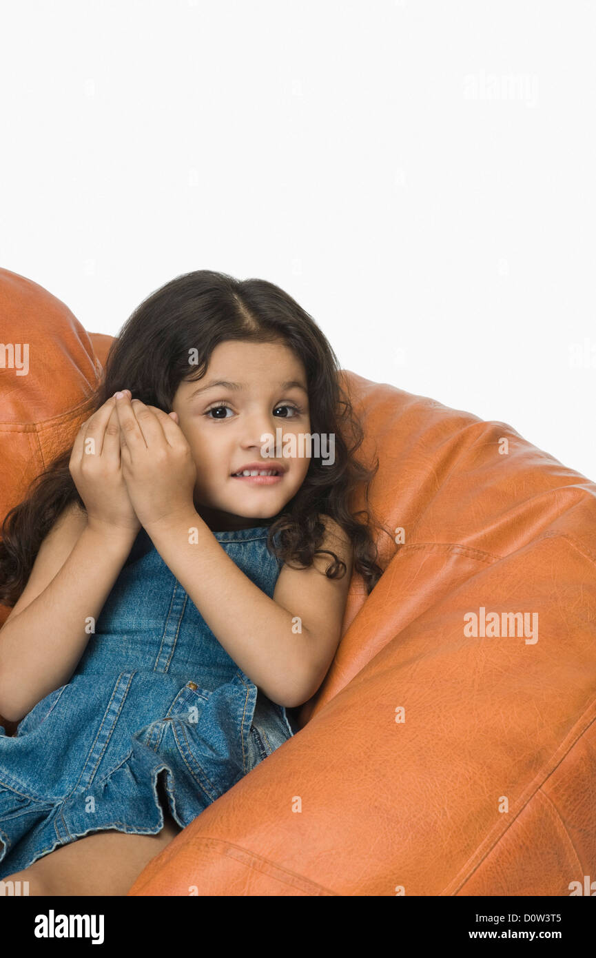 Girl playing on a bean bag Stock Photo - Alamy