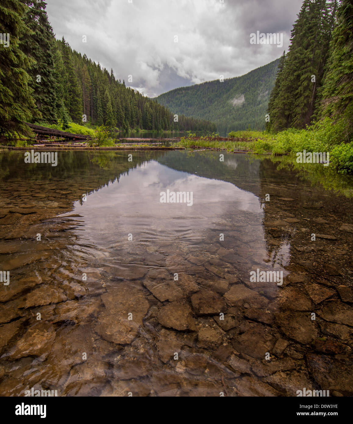 Polarizing filter was used to cut the reflection on the lake to see the rocks on the lake bottom. Stock Photo