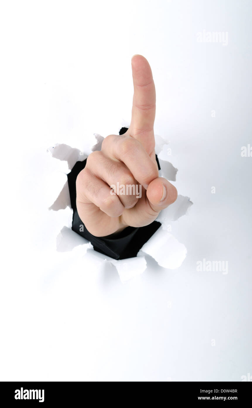 Hand through the hole in paper Stock Photo - Alamy
