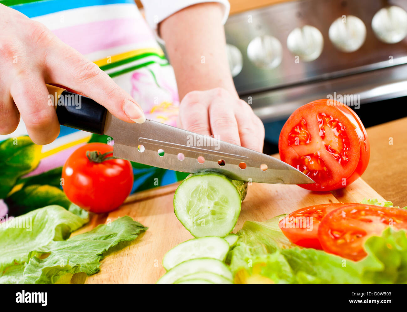 Woman's hands cutting vegetables Stock Photo