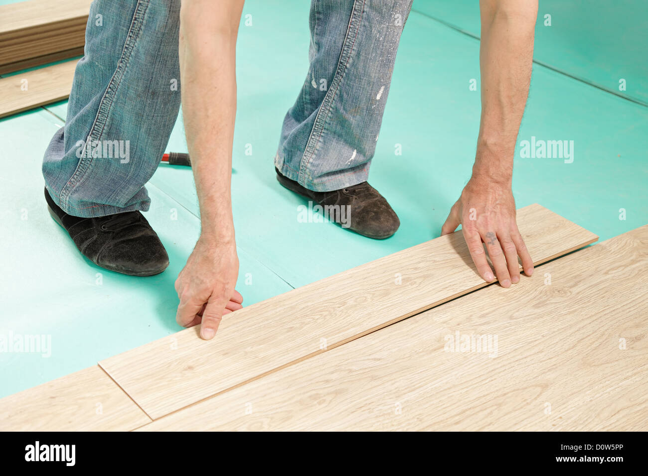 Man installing flooring Stock Photo Alamy