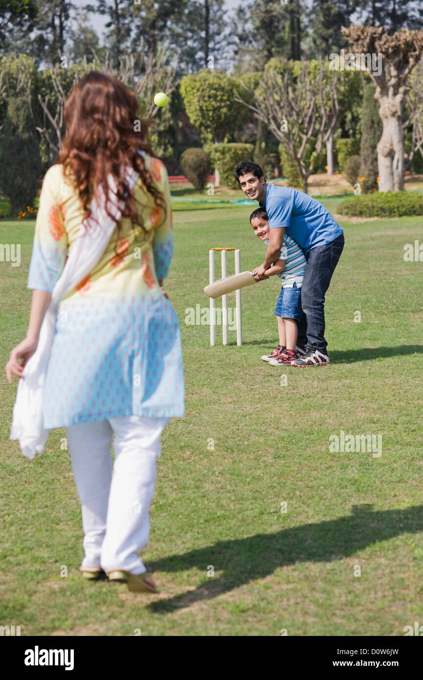 Couple playing cricket with their son, Gurgaon, Haryana, India Stock Photo