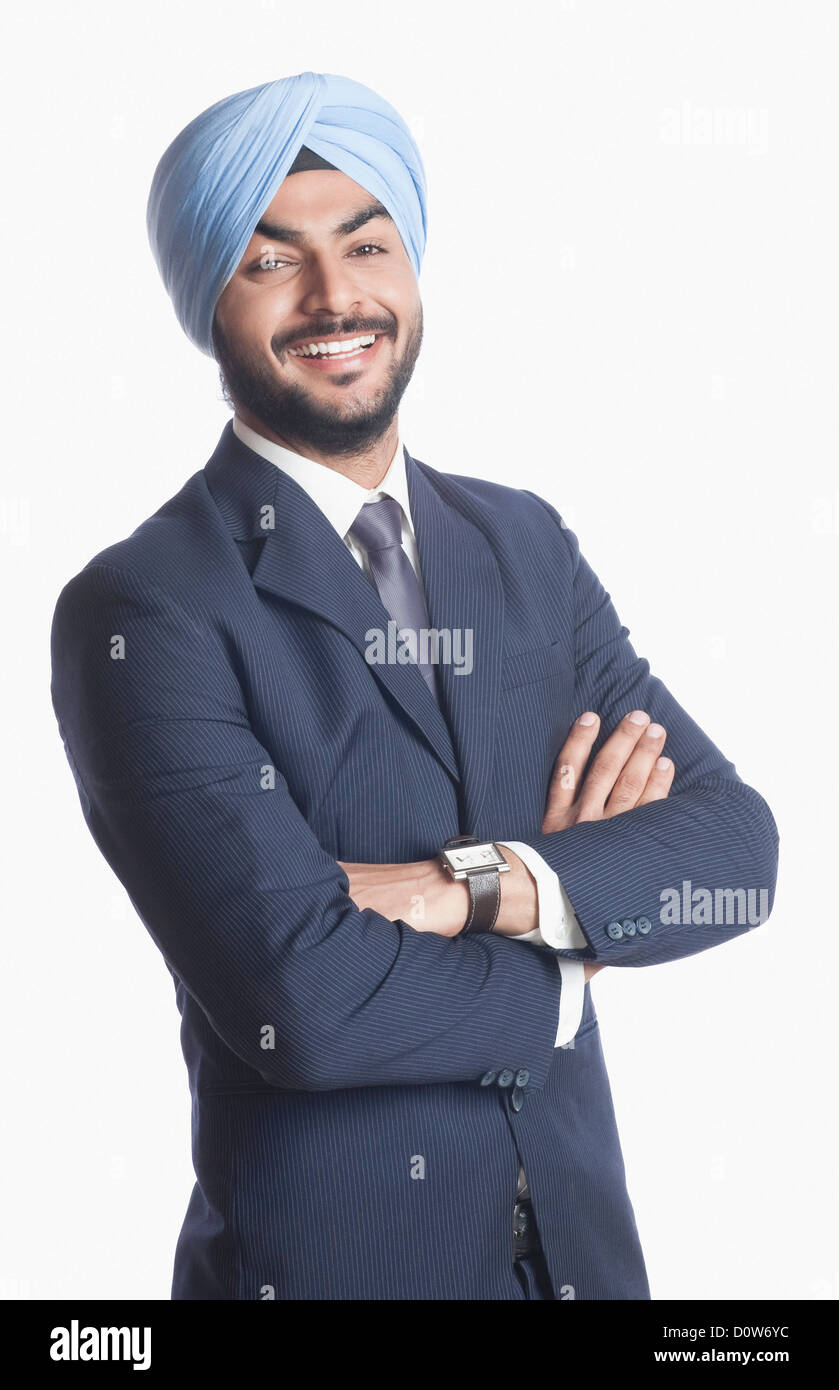 Businessman smiling with arms crossed Stock Photo - Alamy