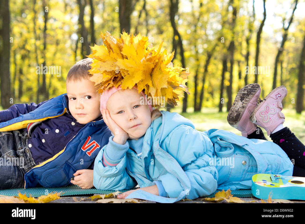 Brother and sister in a park in autumn wearing a hat or crown made of ...