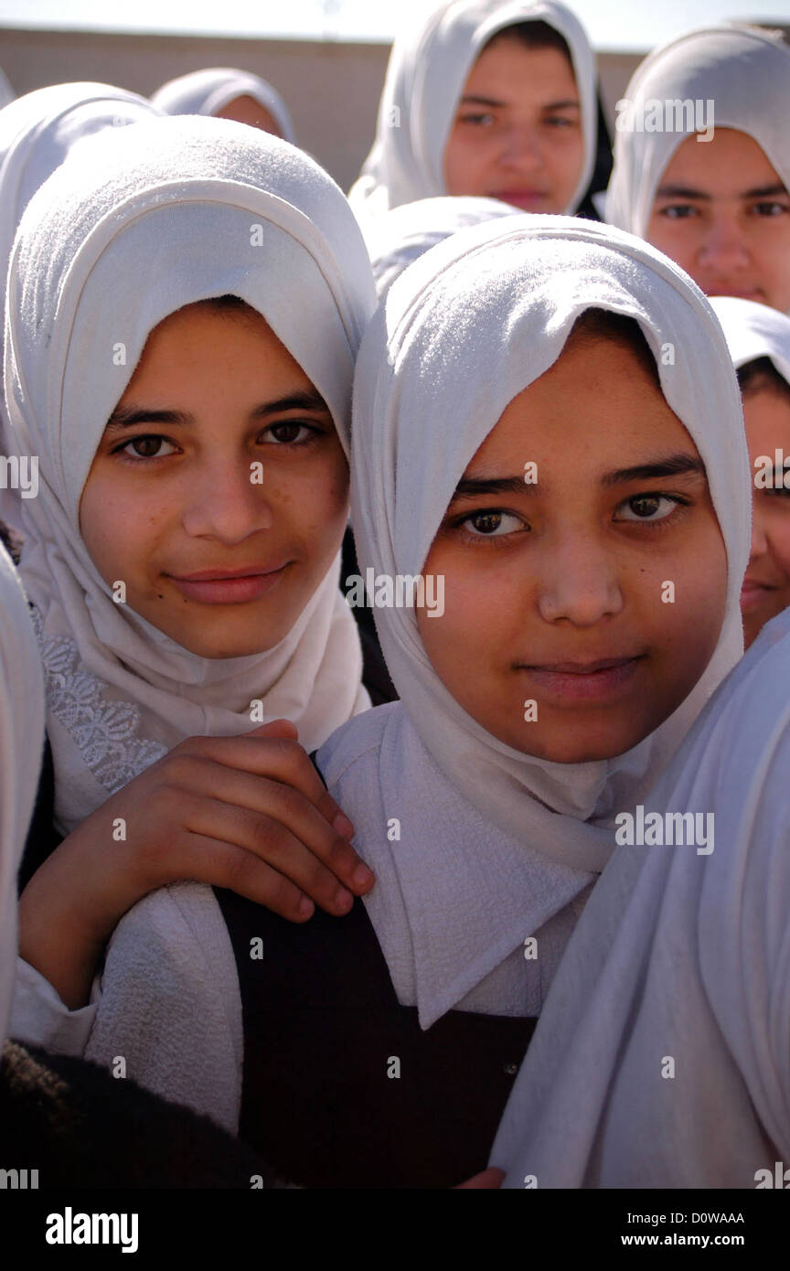 Young Iraqi school girls at the Huda Girls School patiently await the