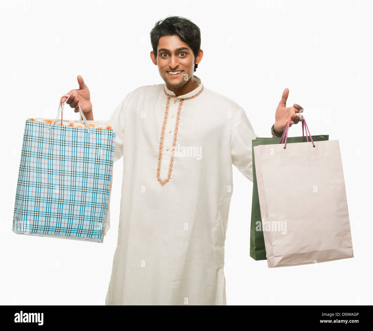 Bengali man carrying shopping bags and smiling Stock Photo Alamy