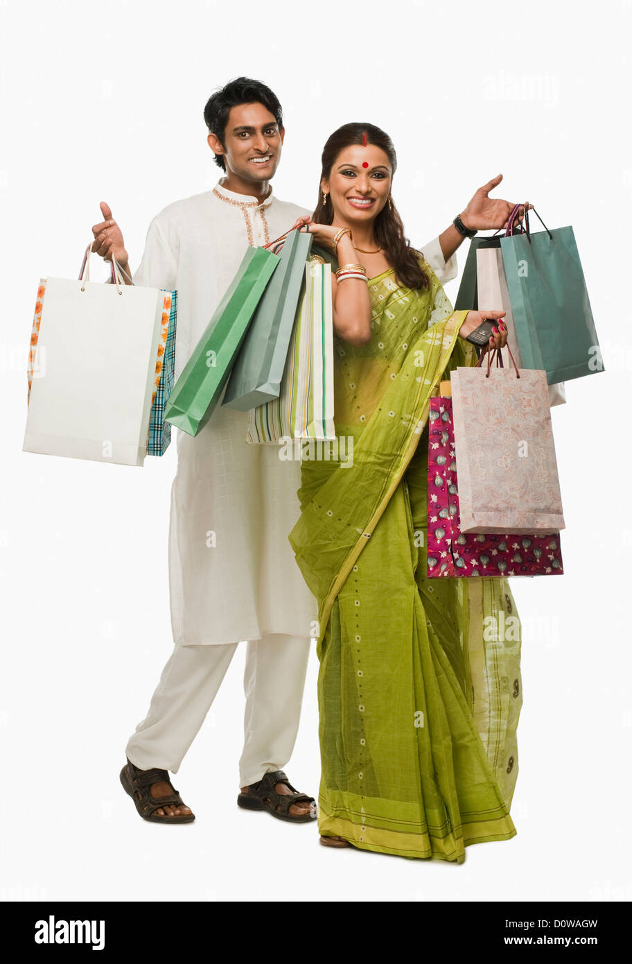 Bengali couple carrying shopping bags and smiling Stock Photo Alamy