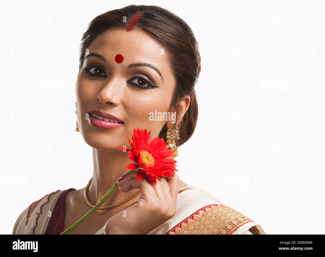 Bengali woman holding a Daisy flower and smiling Stock Photo Alamy