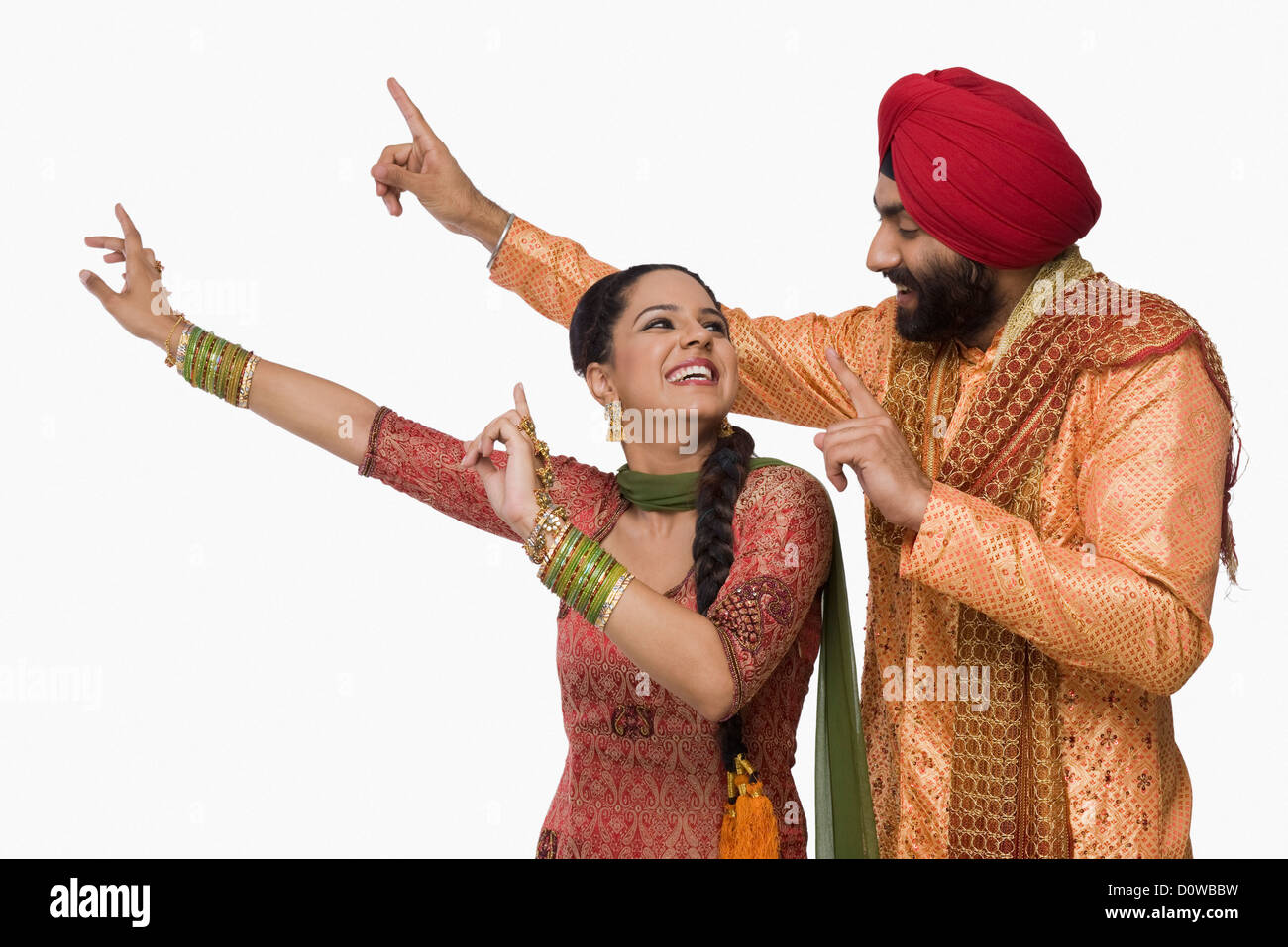Sikh couple doing Bhangra the folk dance of Punjab in India Stock Photo
